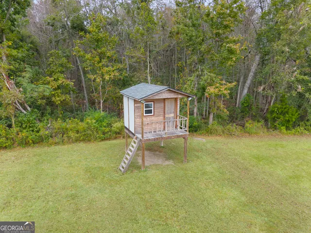 an aerial view of a house with a yard