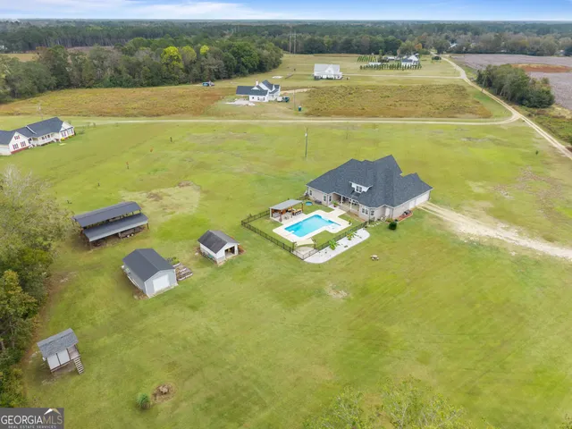 a view of a swimming pool and a yard