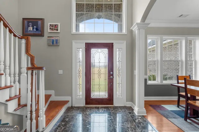 a view of a hallway with furniture and front door