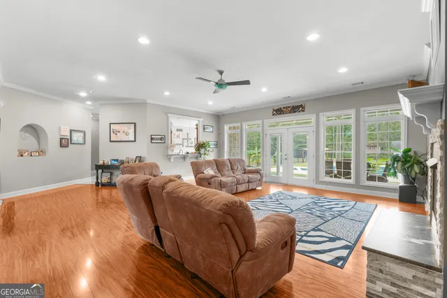 a living room with furniture and large windows