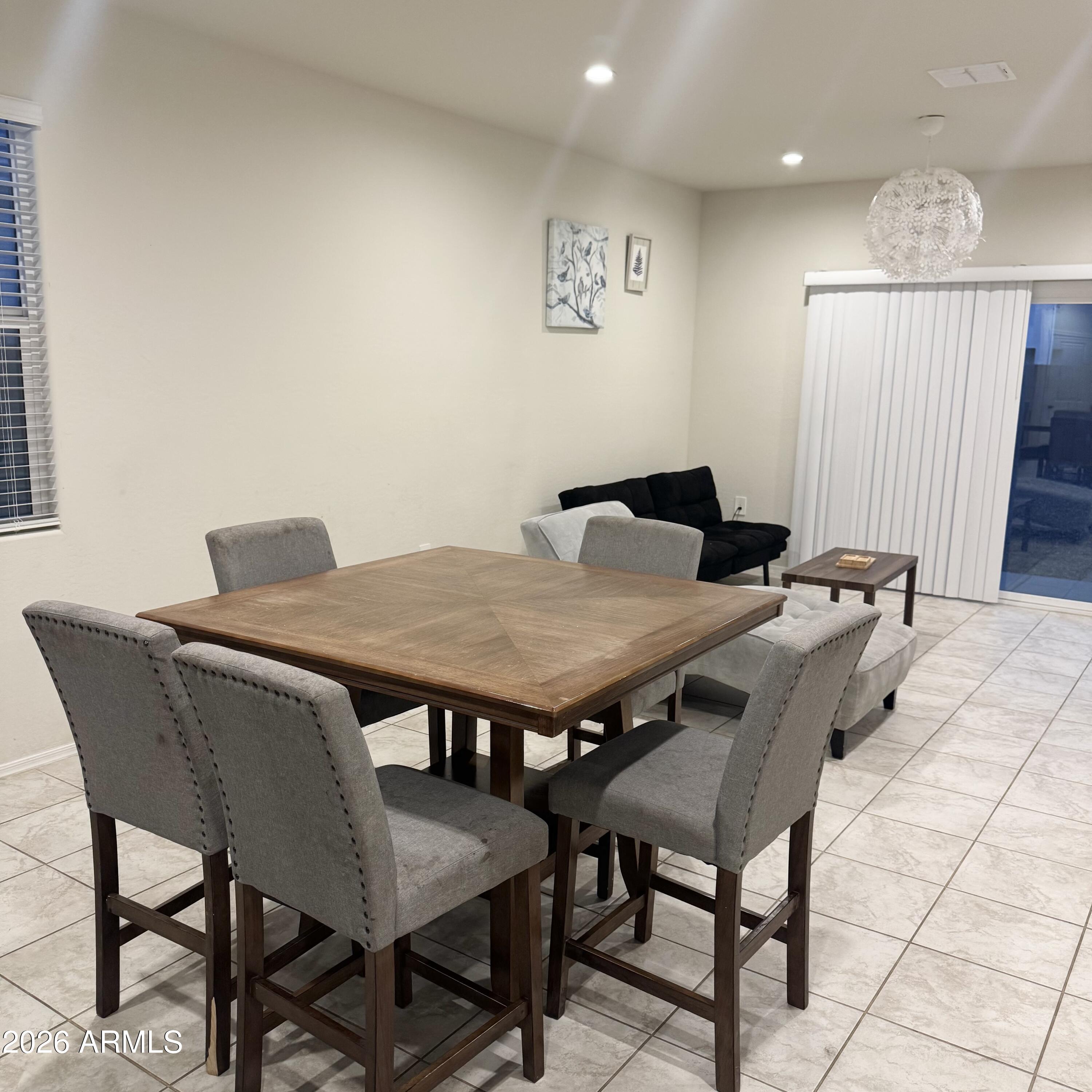5208 East Emery Road San Tan Valley, AZ 85143 - Photo 12 of 30 a view of a dining table and chairs in a room