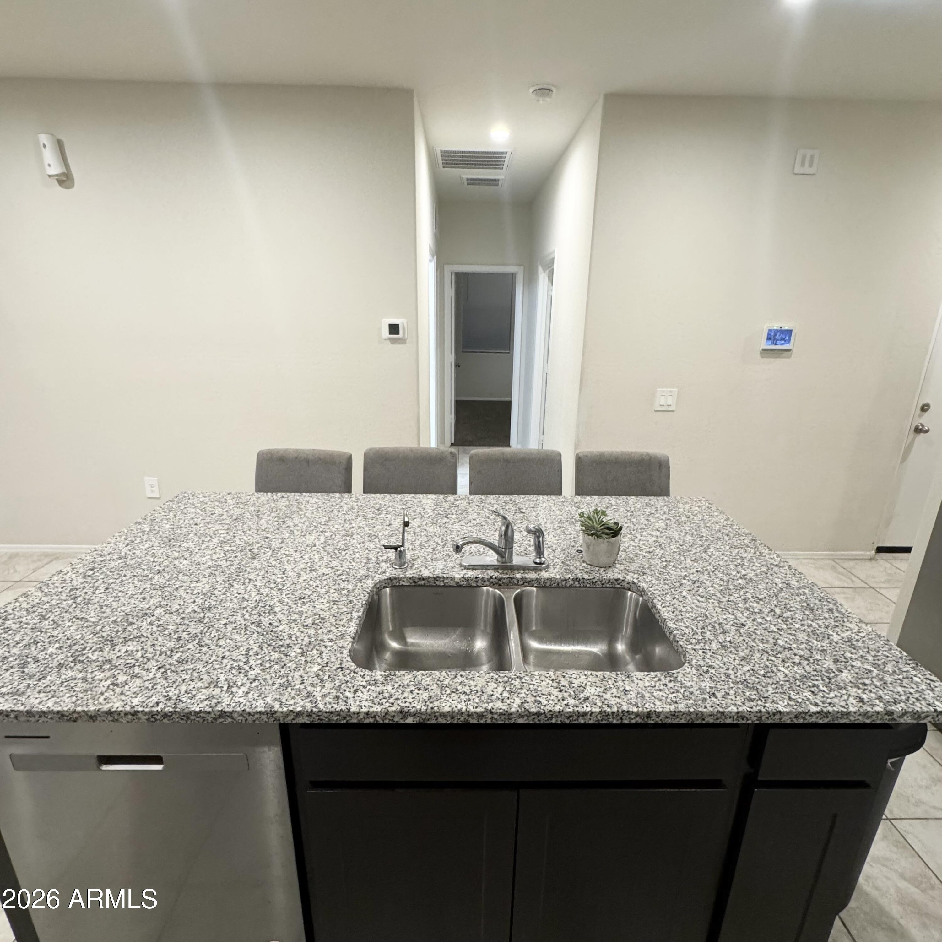 5208 East Emery Road San Tan Valley, AZ 85143 - Photo 13 of 30 a bathroom with a granite countertop sink and a mirror