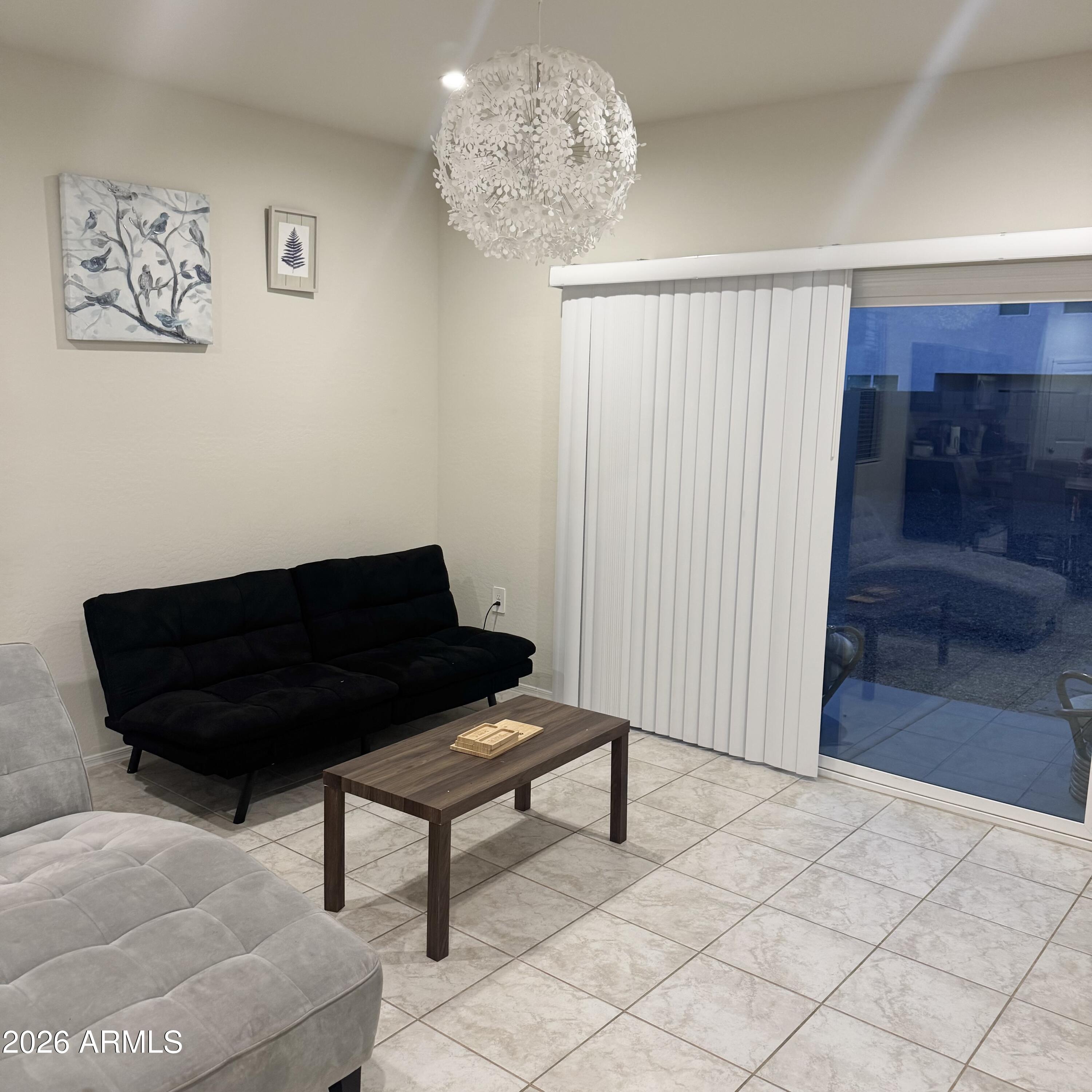 5208 East Emery Road San Tan Valley, AZ 85143 - Photo 14 of 30 a living room with a couch and a potted plant