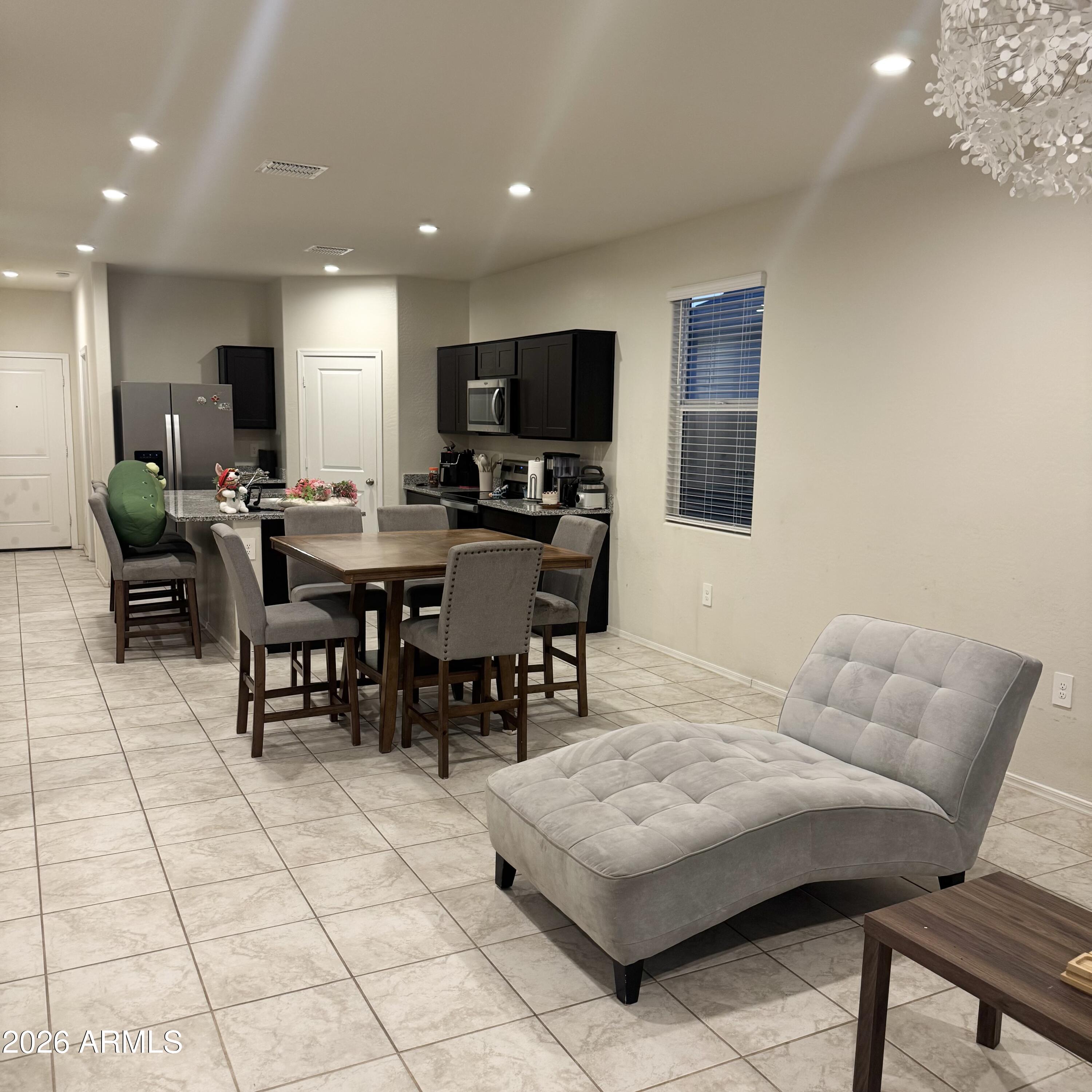 5208 East Emery Road San Tan Valley, AZ 85143 - Photo 15 of 30 a living room with furniture a flat screen tv and kitchen view