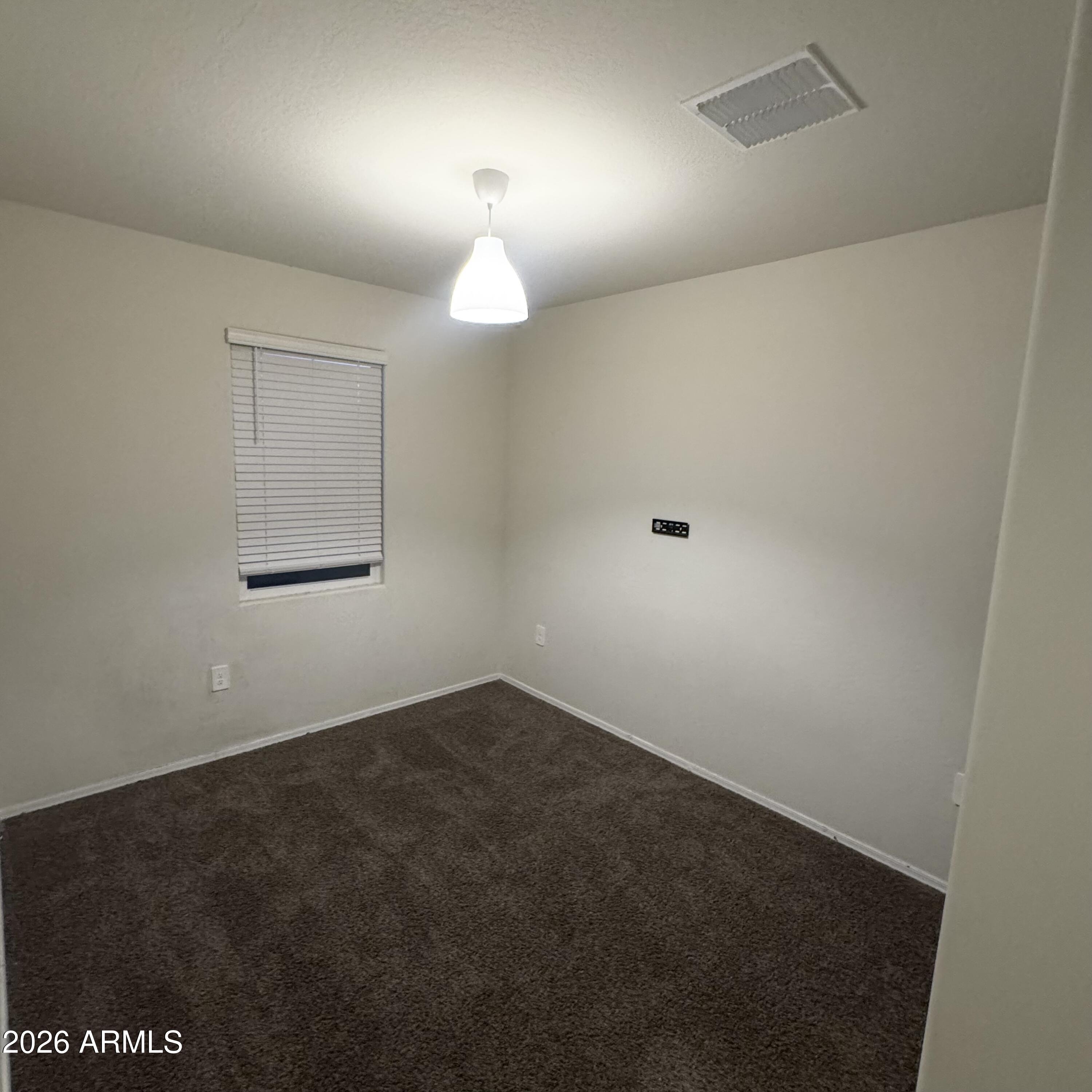 5208 East Emery Road San Tan Valley, AZ 85143 - Photo 25 of 30 an empty room with a fan and a window