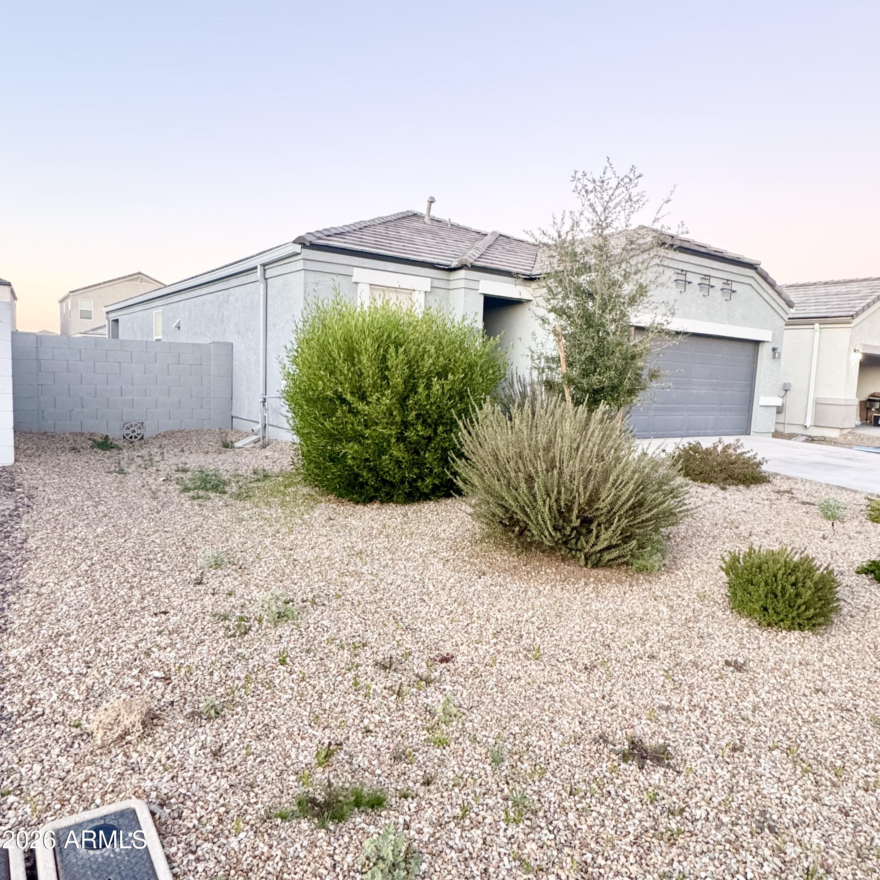 5208 East Emery Road San Tan Valley, AZ 85143 - Photo 7 of 30 a view of a house with a yard and potted plants