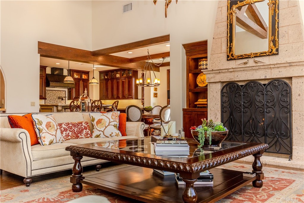 17 Cassis Circle Rancho Mirage, CA 92270 - Photo 15 of 75 a living room with furniture a fireplace and potted plants