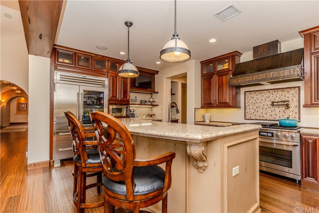 17 Cassis Circle Rancho Mirage, CA 92270 - Photo 18 of 75 a kitchen with stainless steel appliances granite countertop a stove and a refrigerator