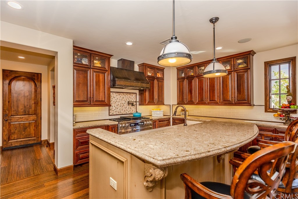 17 Cassis Circle Rancho Mirage, CA 92270 - Photo 19 of 75 a kitchen with a table chairs and a chandelier
