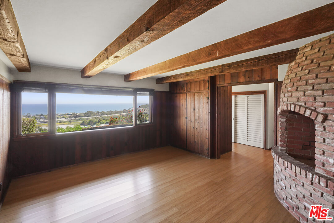 3217 Colony View Circle Malibu, CA 90265 - Photo 8 of 23 an empty room with wooden floor and windows