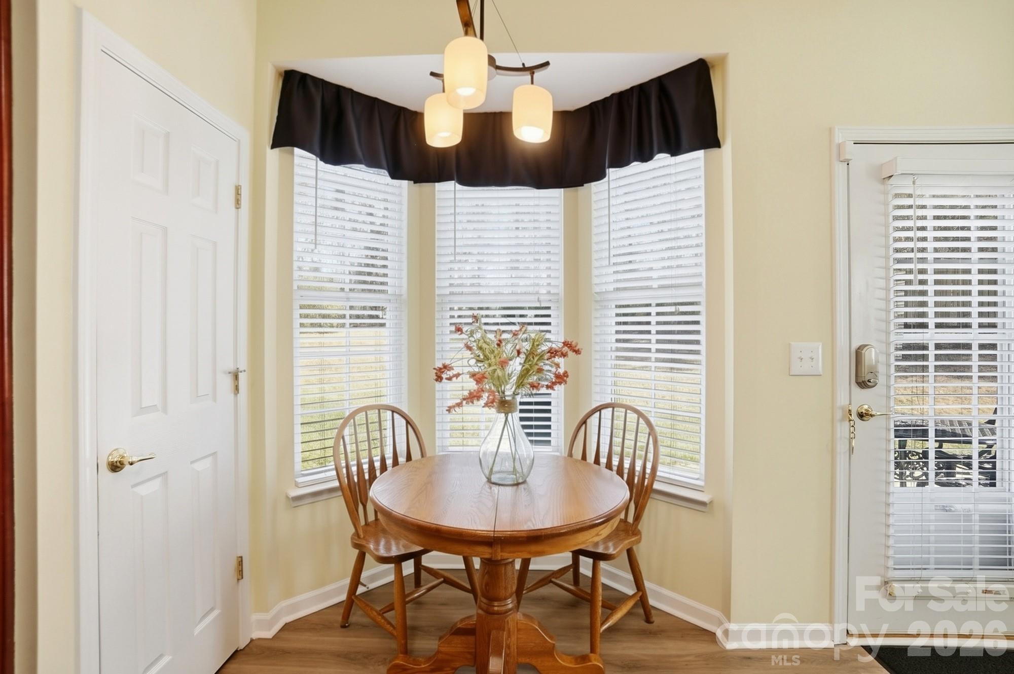 1667 Onyx Ridge Fort Mill, SC 29708 - Photo 11 of 25 a view of a dining room with furniture and chandelier