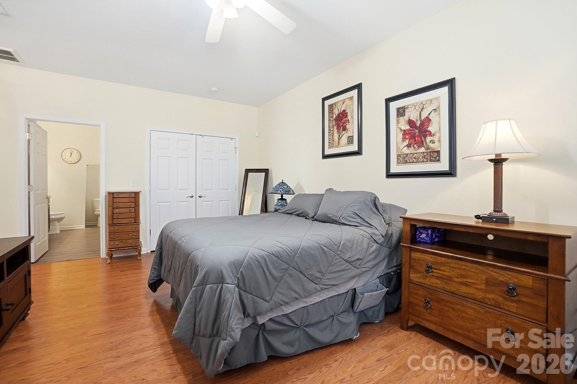 1667 Onyx Ridge Fort Mill, SC 29708 - Photo 17 of 25 a bedroom with a bed and wooden floor