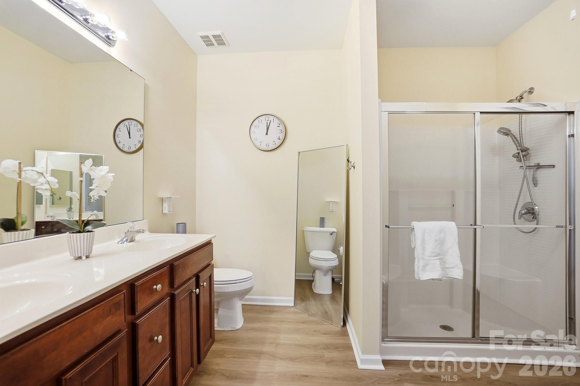 1667 Onyx Ridge Fort Mill, SC 29708 - Photo 18 of 25 a bathroom with a double vanity sink mirror and shower