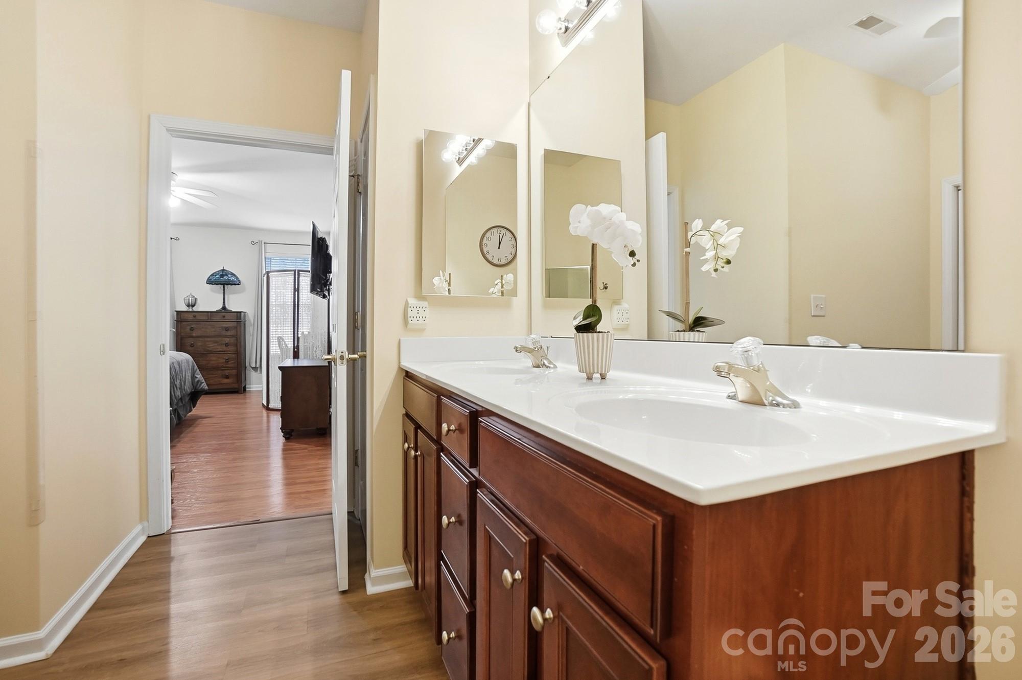 1667 Onyx Ridge Fort Mill, SC 29708 - Photo 19 of 25 a bathroom with a sink a mirror and a shower
