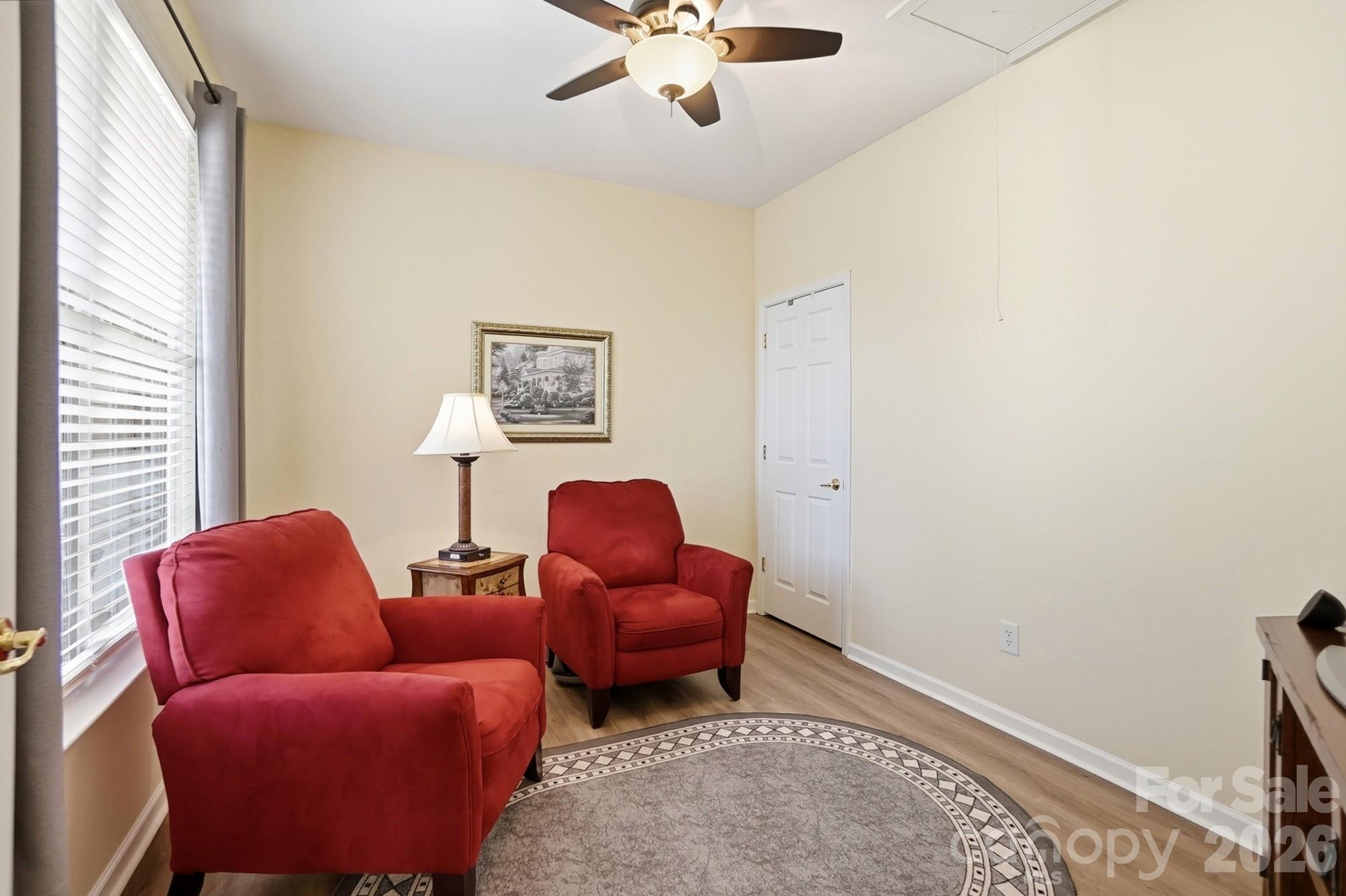 1667 Onyx Ridge Fort Mill, SC 29708 - Photo 21 of 25 a living room with furniture a ceiling fan and a window
