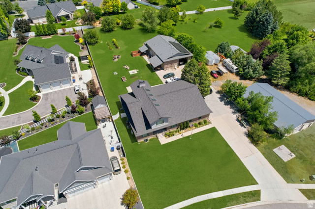 580 North 300 East Logan, UT 84321 - Photo 13 of 74 Expansive property featuring a large residence with an attached multi-car garage, a detached accessory dwelling unit, a large detached metal-roofed outbuilding, and extensive manicured lawns