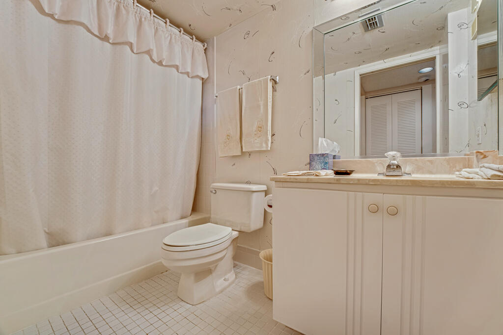 7301 Amberly Lane, Unit 407 Delray Beach, FL 33446 - Photo 18 of 23 a bathroom with a sink toilet and shower
