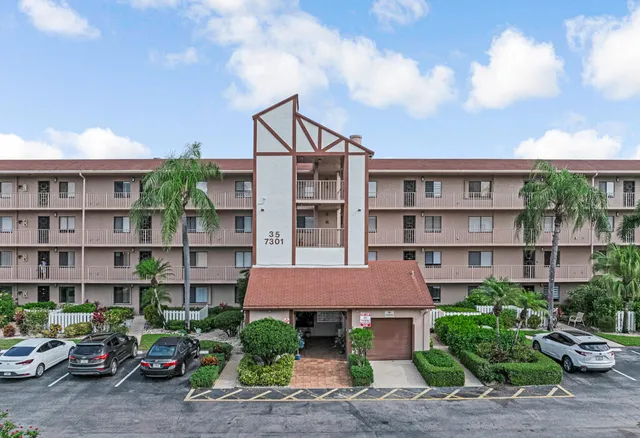 a front view of a house with a garden and plants