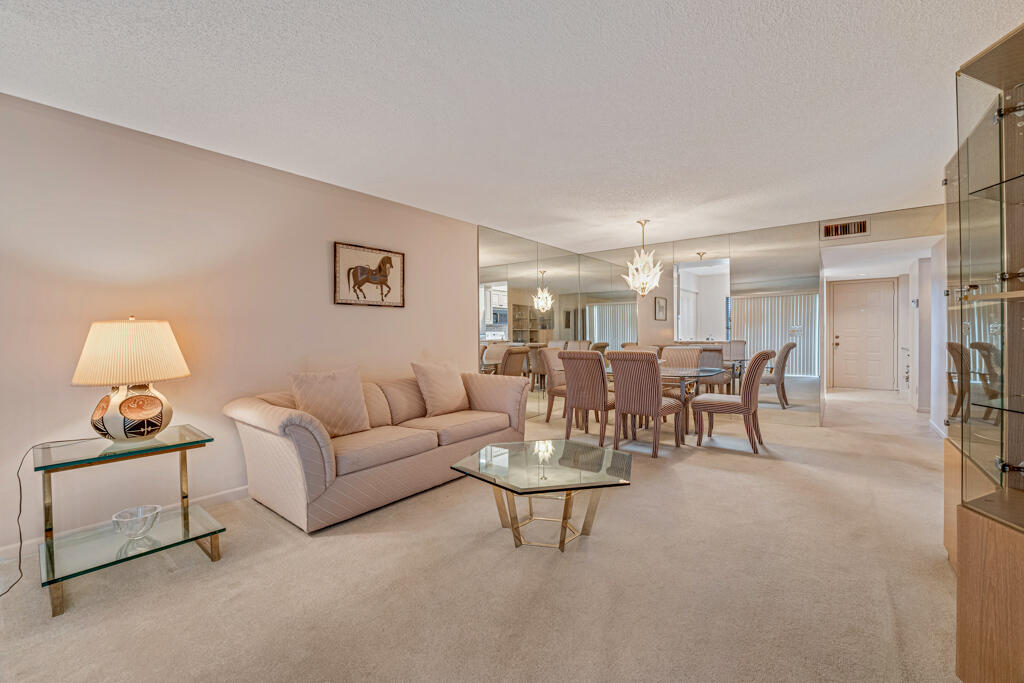 7301 Amberly Lane, Unit 407 Delray Beach, FL 33446 - Photo 5 of 23 a living room with furniture and a lamp