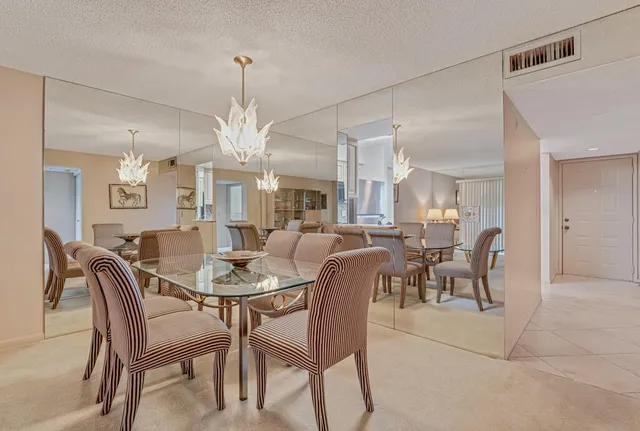 a view of a dining room with furniture and a chandelier