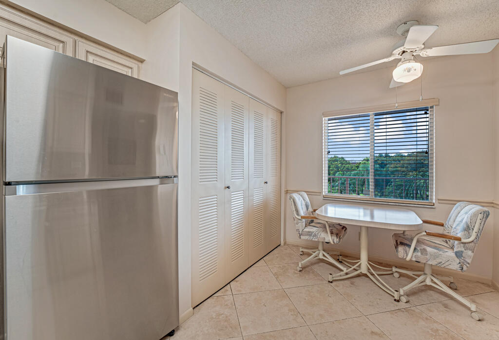 7301 Amberly Lane, Unit 407 Delray Beach, FL 33446 - Photo 10 of 23 a dining room with furniture and window
