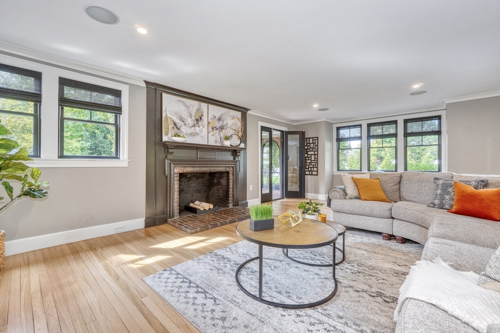 27 Cabot Street Winchester, MA 01890 - Photo 18 of 42 a living room with furniture a fireplace and a table