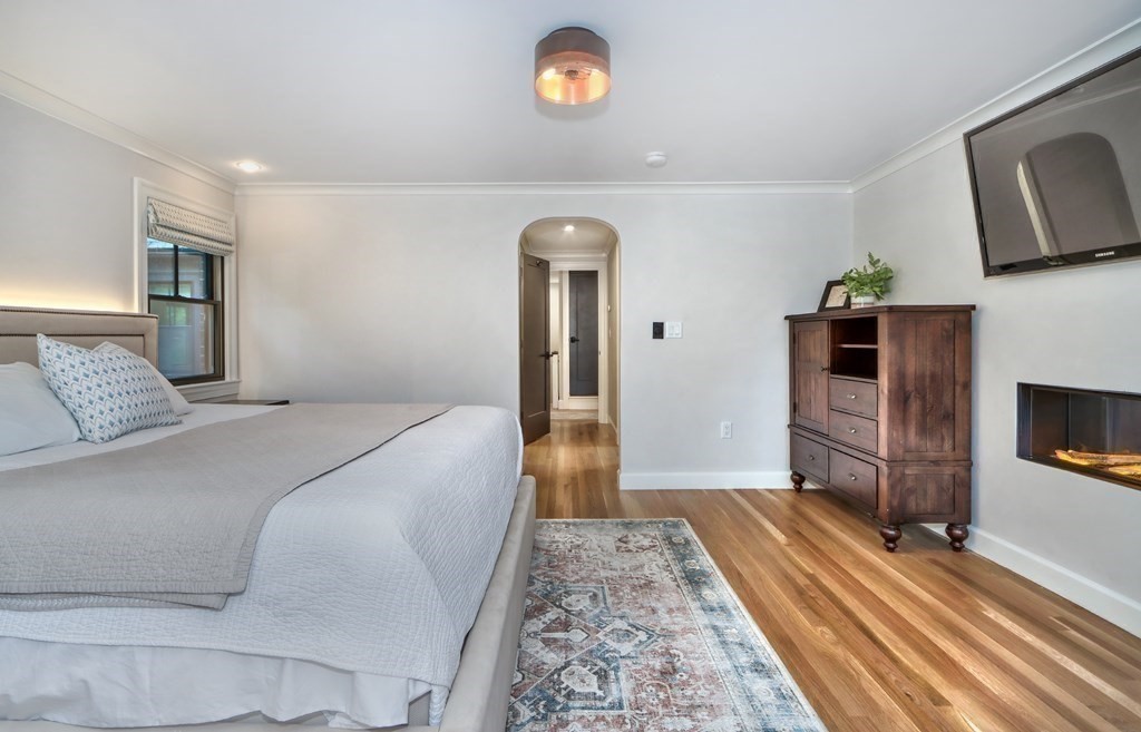 27 Cabot Street Winchester, MA 01890 - Photo 25 of 42 a bedroom with a bed and a flat screen tv