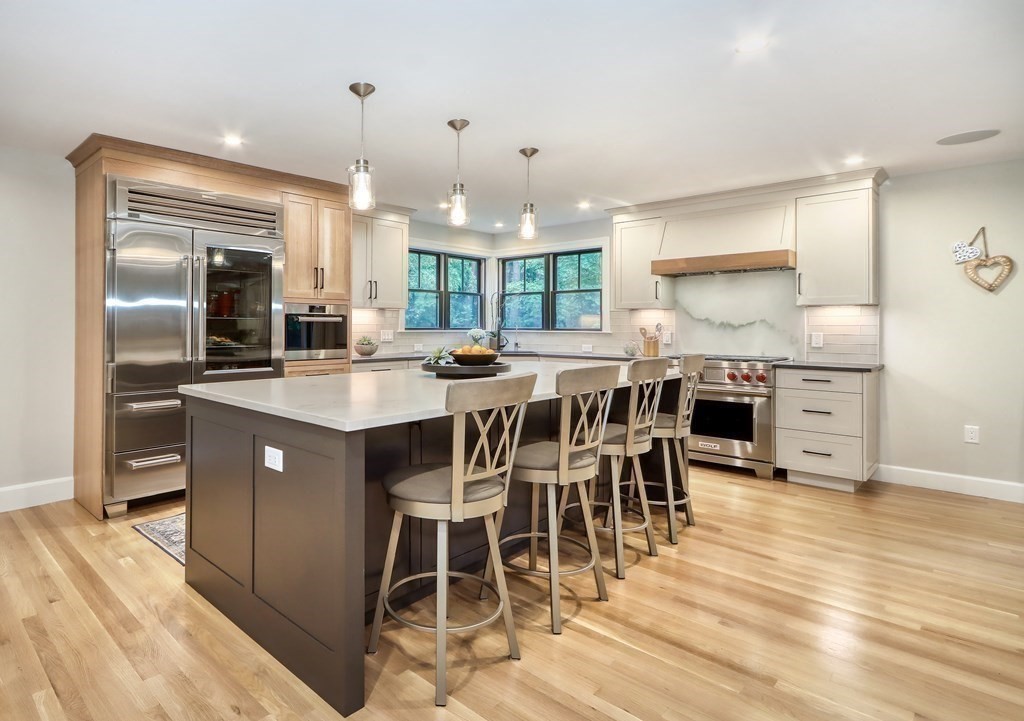 27 Cabot Street Winchester, MA 01890 - Photo 3 of 42 a kitchen with stainless steel appliances granite countertop a sink a stove and a refrigerator