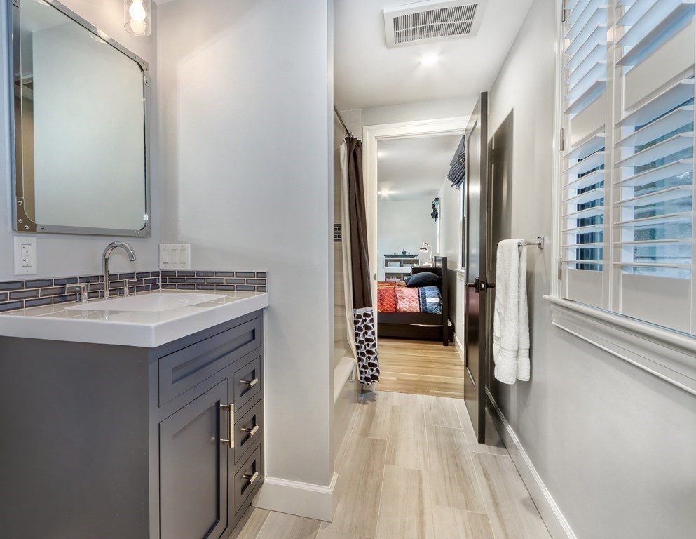 27 Cabot Street Winchester, MA 01890 - Photo 32 of 42 a en suite bathroom with a sink and a mirror