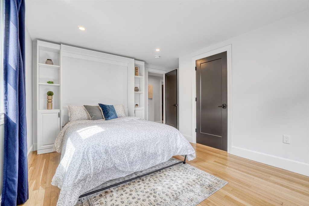 27 Cabot Street Winchester, MA 01890 - Photo 33 of 42 a bedroom with a bed and wooden floor