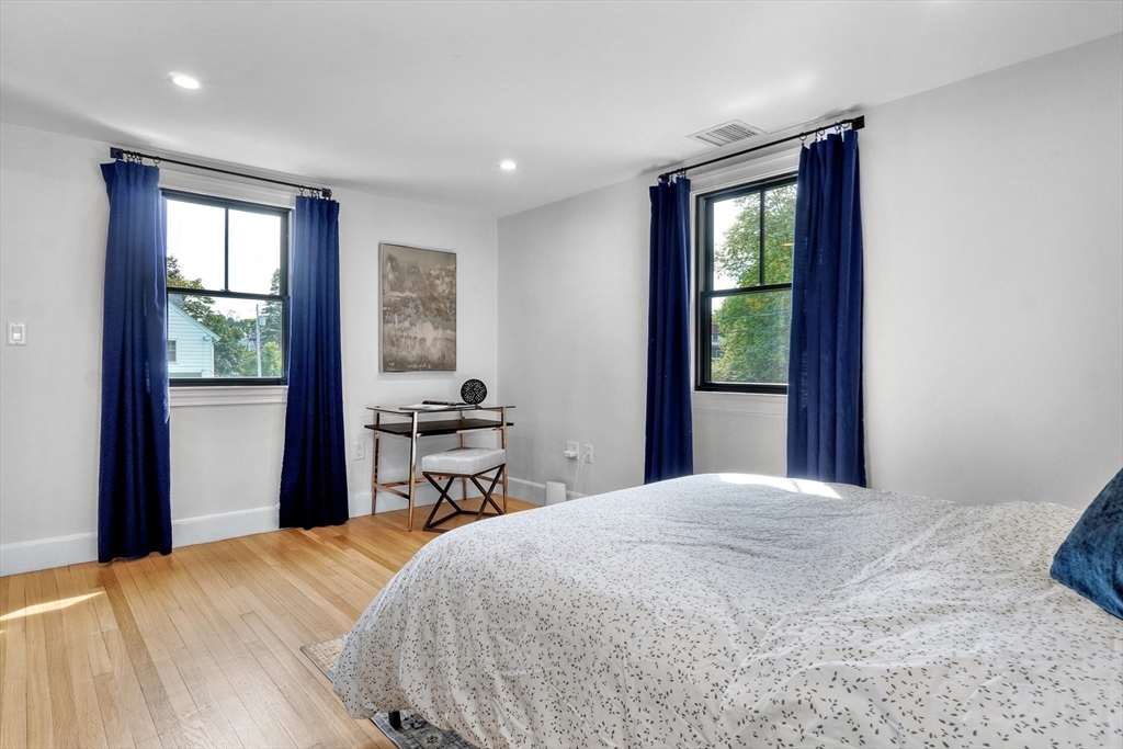 27 Cabot Street Winchester, MA 01890 - Photo 34 of 42 a bedroom with a large bed and a large window