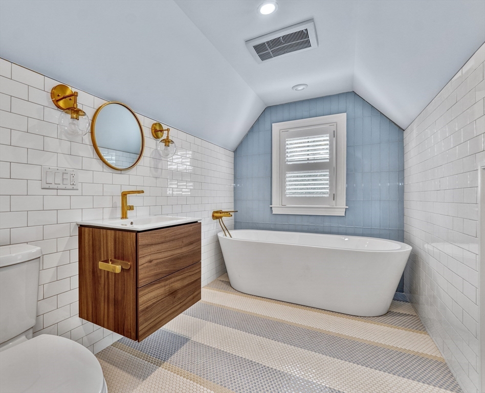 27 Cabot Street Winchester, MA 01890 - Photo 37 of 42 a bathroom with a sink mirror and window