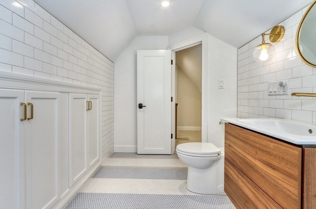 27 Cabot Street Winchester, MA 01890 - Photo 38 of 42 a bathroom with a granite countertop toilet a sink and a shower