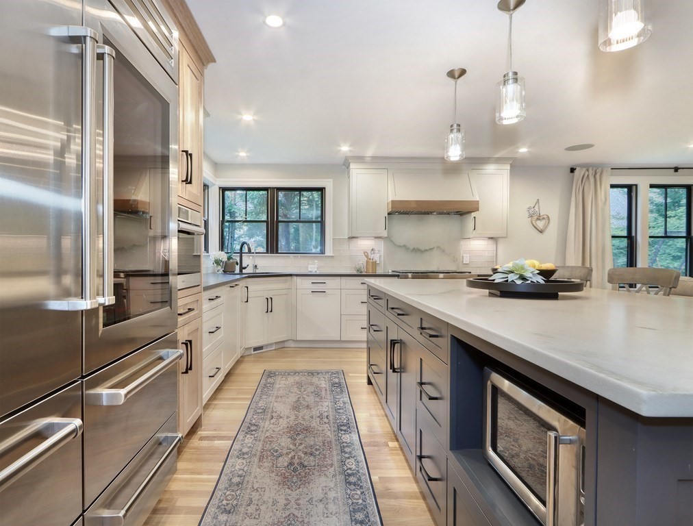 27 Cabot Street Winchester, MA 01890 - Photo 5 of 42 a large kitchen with stainless steel appliances granite countertop a sink and cabinets