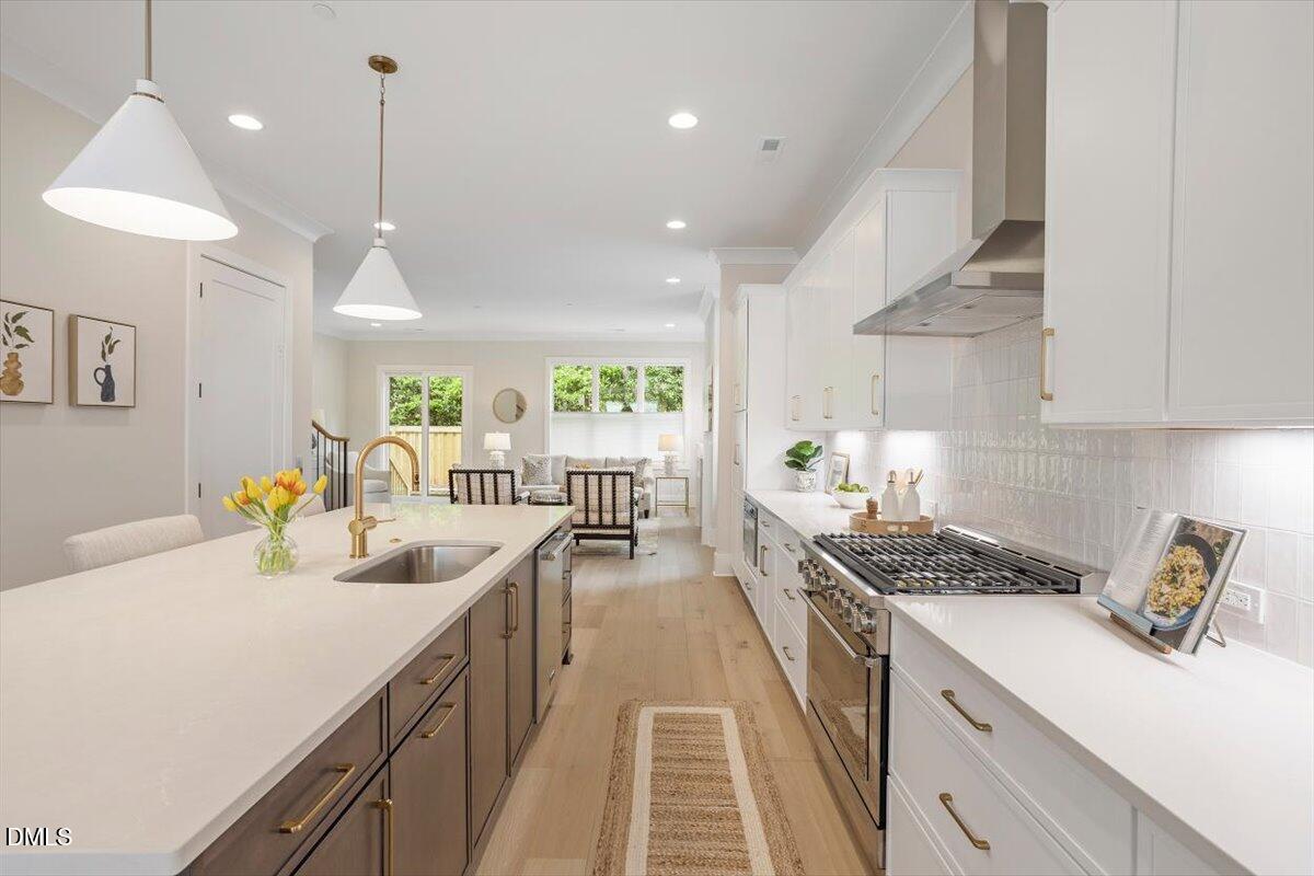 811 Maple Berry Lane, Unit 101 Raleigh, NC 27607 - Photo 9 of 45 a kitchen with a sink stove and cabinets