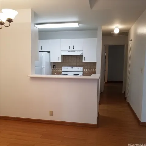 a kitchen with kitchen island a sink a stove and a refrigerator