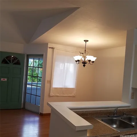 a view of a room with wooden floor and staircase