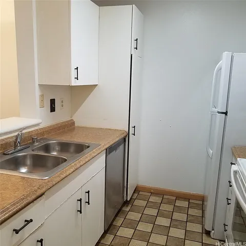 a white toilet sitting next to a bath tub
