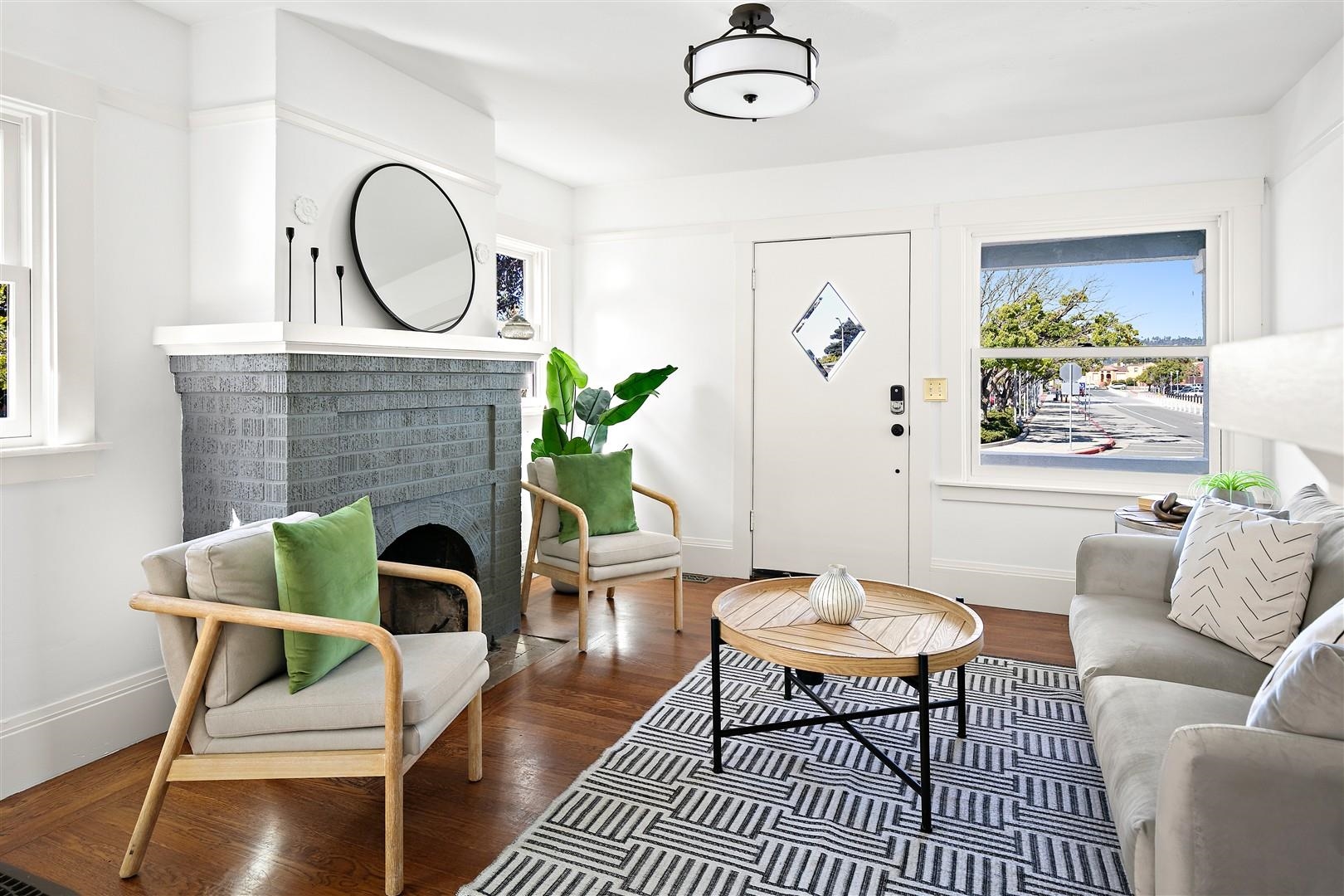 1436 Delaware Street Berkeley, CA 94702 - Photo 11 of 60 Living area featuring a brick fireplace and wood finished floors