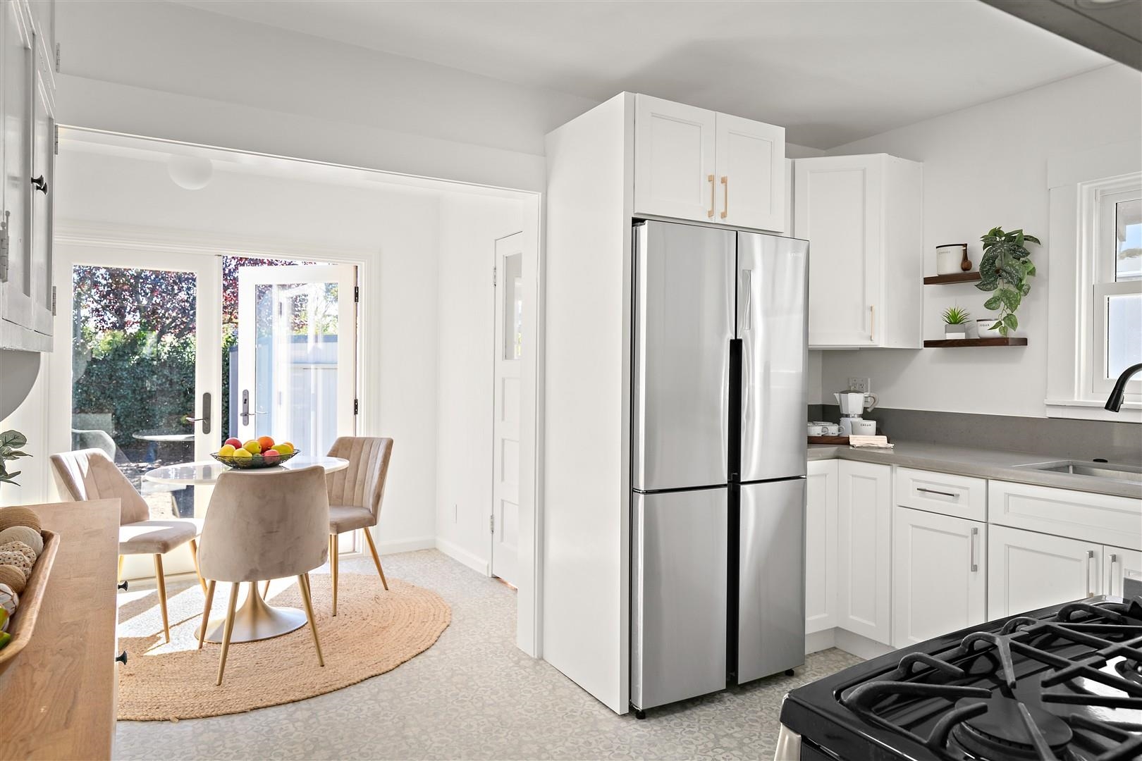 1436 Delaware Street Berkeley, CA 94702 - Photo 15 of 60 Kitchen with white cabinetry, freestanding refrigerator, black gas range, and open shelves