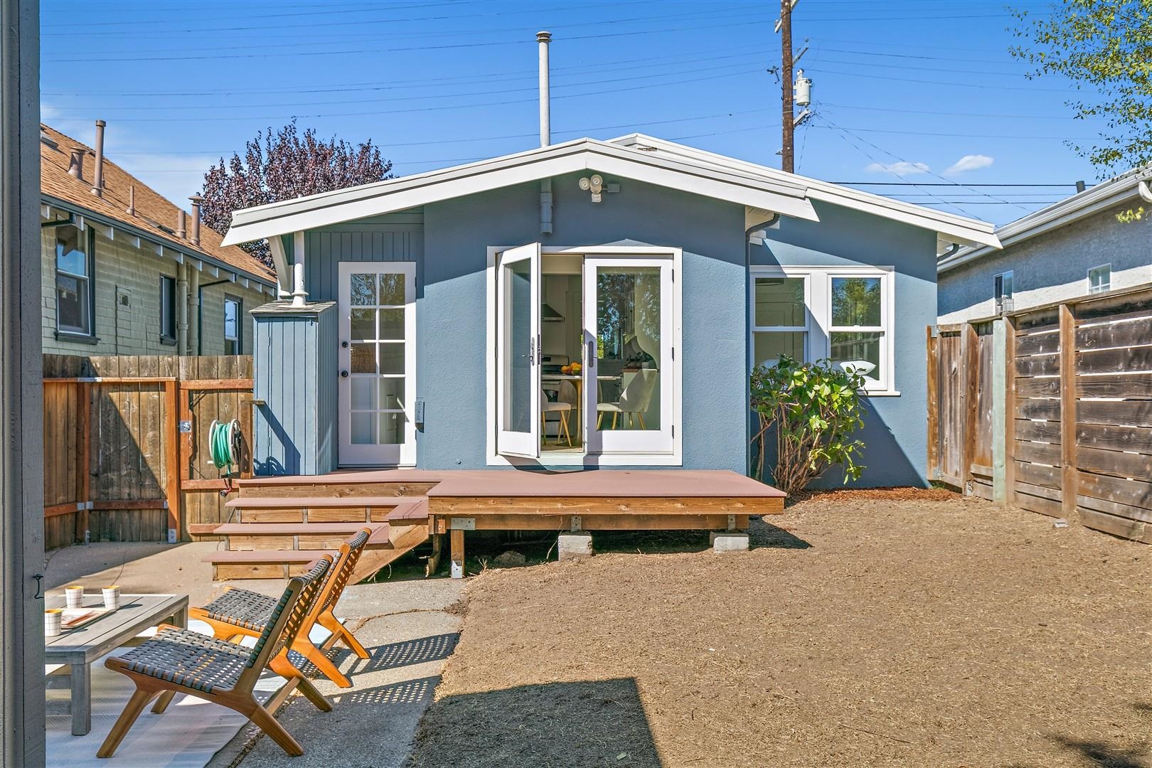 1436 Delaware Street Berkeley, CA 94702 - Photo 27 of 60 Back of house with a wooden deck, stucco siding, and a fenced backyard