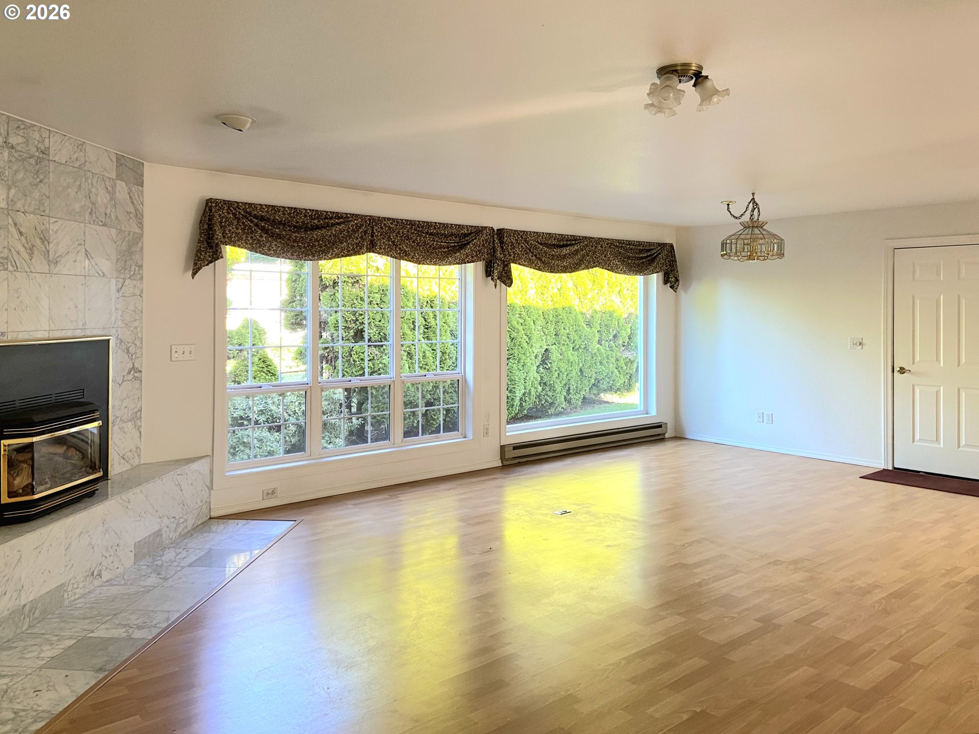 15482 Morrison Lane Brookings, OR 97415 - Photo 14 of 42 a view of an empty room with a window and wooden floor