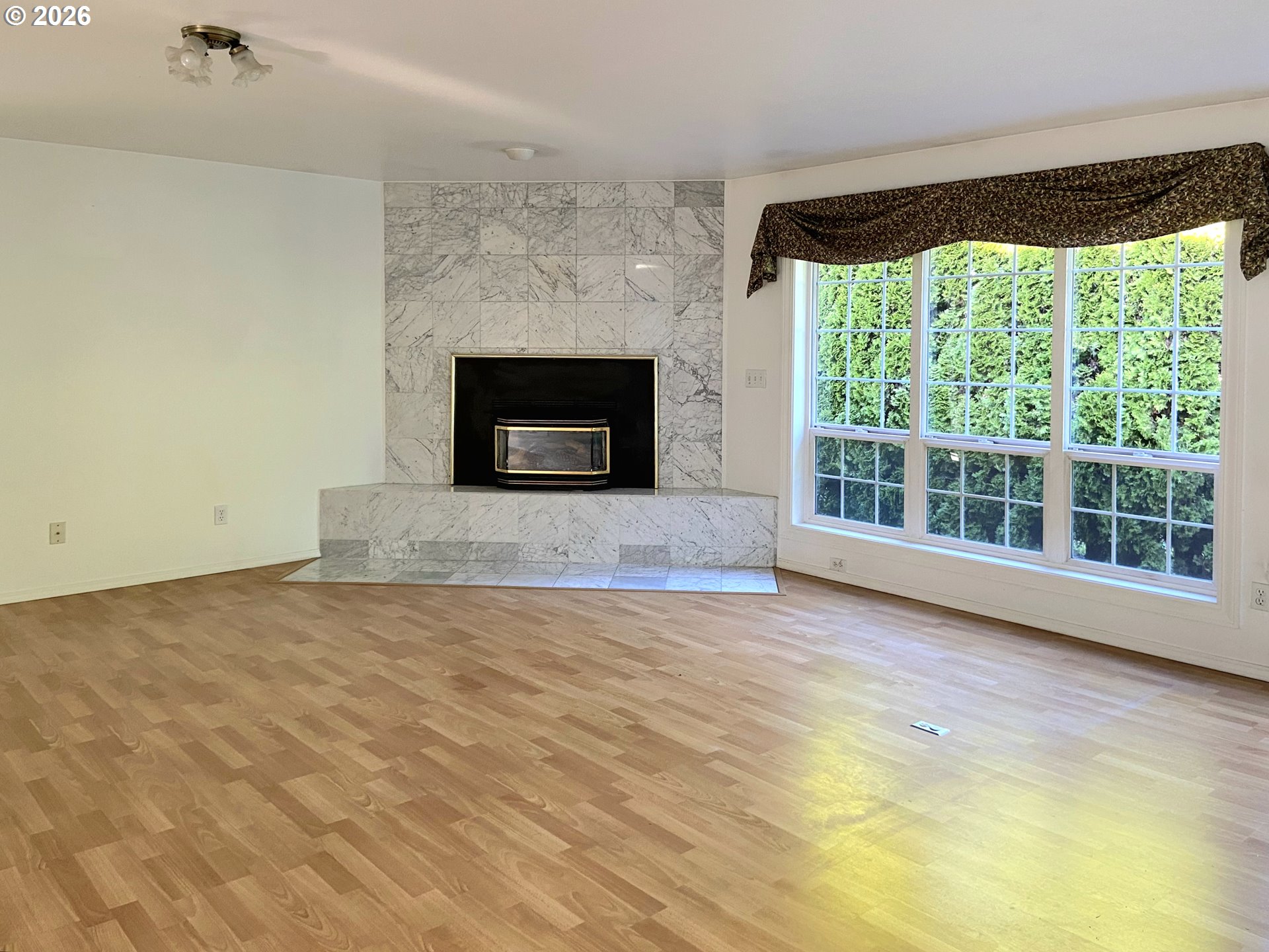 15482 Morrison Lane Brookings, OR 97415 - Photo 15 of 42 a view of empty room with wooden floor and fireplace