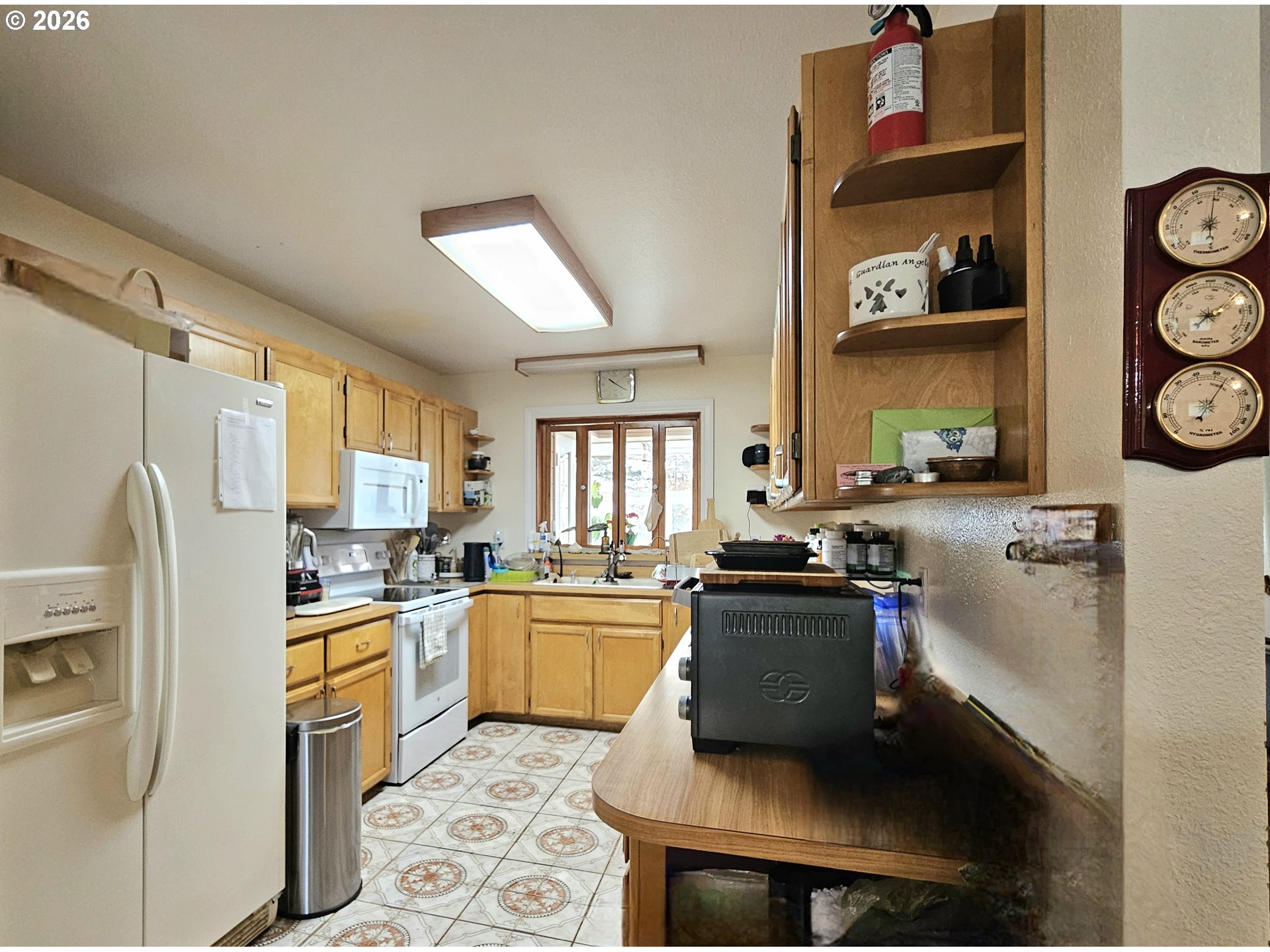 15482 Morrison Lane Brookings, OR 97415 - Photo 17 of 42 a kitchen with a stove a sink and a refrigerator