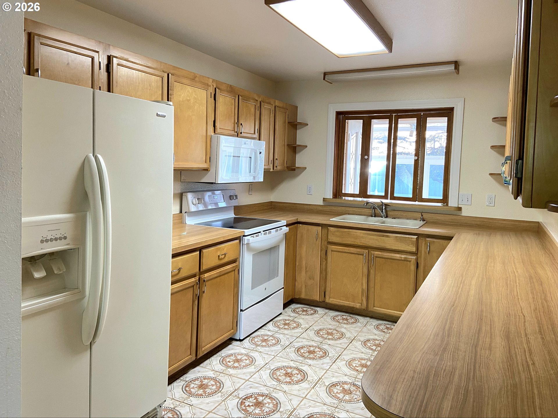 15482 Morrison Lane Brookings, OR 97415 - Photo 18 of 42 a kitchen with a refrigerator sink and cabinets