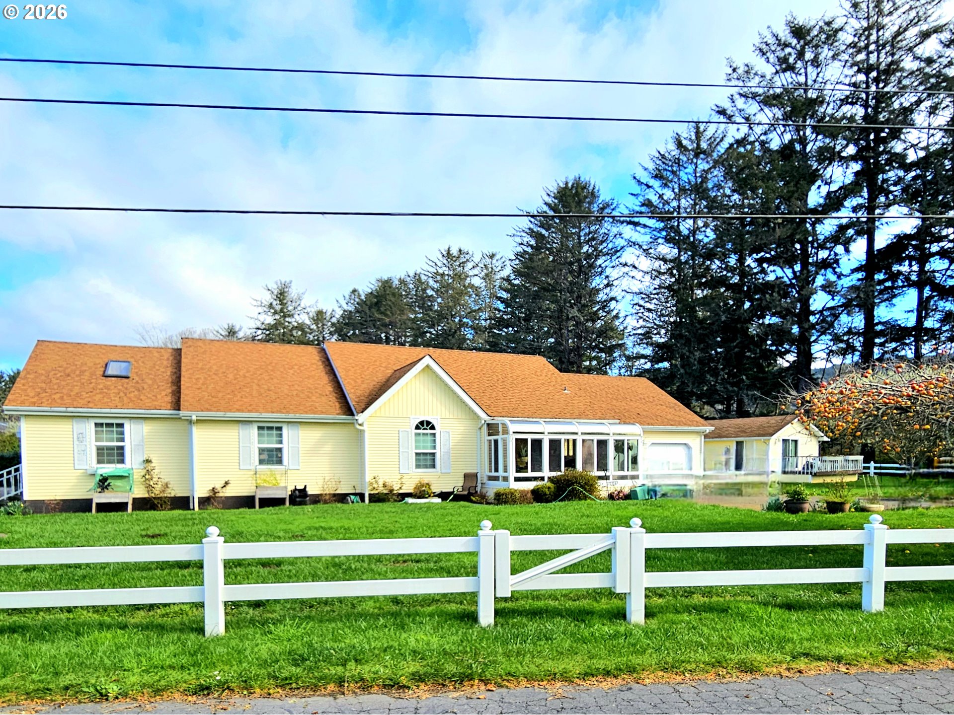 15482 Morrison Lane Brookings, OR 97415 - Photo 2 of 42 a view of big white house with a big yard and large trees