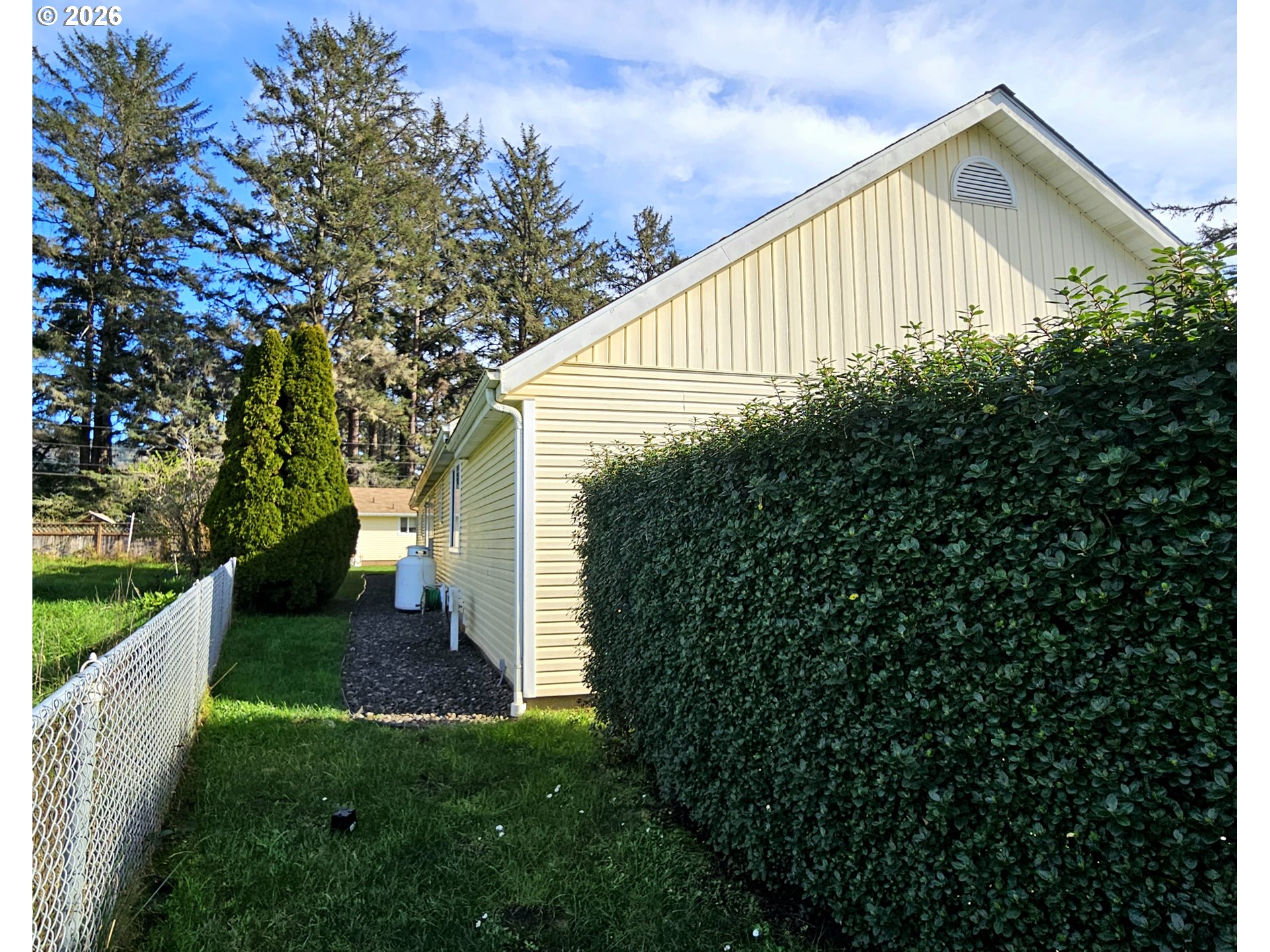 15482 Morrison Lane Brookings, OR 97415 - Photo 40 of 42 a view of a house with backyard and garden