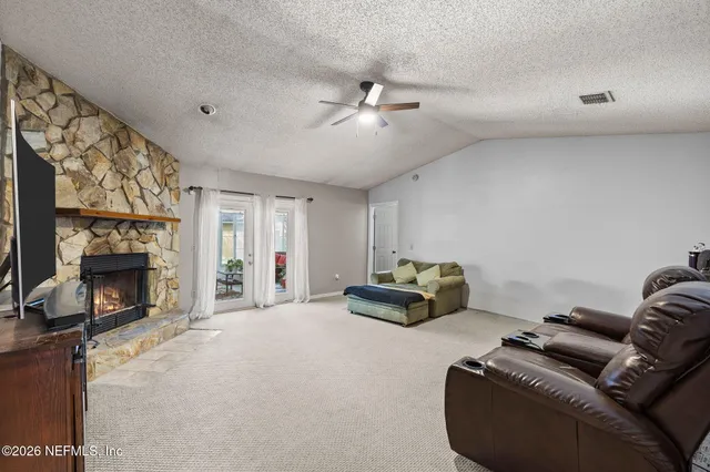 a bathroom with a granite countertop sink a toilet and a mirror