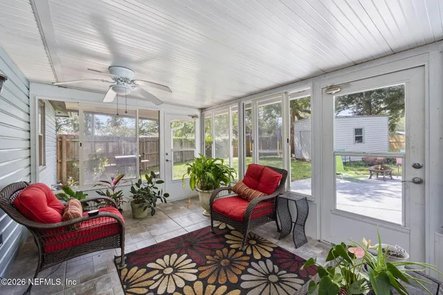 a view of house in front of a big yard with large trees