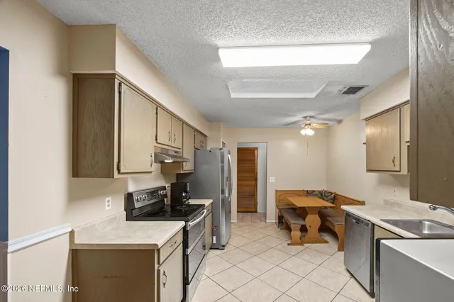 a bedroom with furniture a flat screen tv and a fireplace